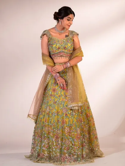 A full-length shot of the lime green lehenga, showing how the skirt moves and the beautiful contrast of the multi-colored embroidery.