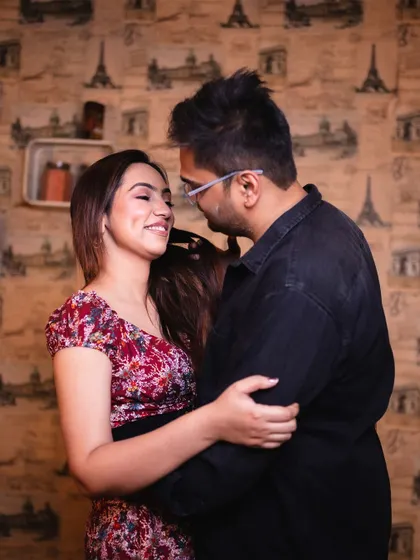 An intimate embrace against a beautifully wallpapered backdrop. This photo from their cooking-themed shoot feels warm, personal, and full of love.
