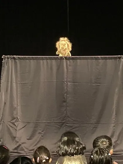 A little lion puppet captivates a young audience. This is from one of my 'Puppets & Stories' shows, designed to give children and their families an early and magical experience with theatre.