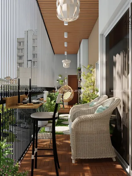 This balcony design includes a sleek bar-height counter for enjoying the view with a cup of coffee. The combination of wicker chairs and lush greenery creates a relaxing atmosphere.