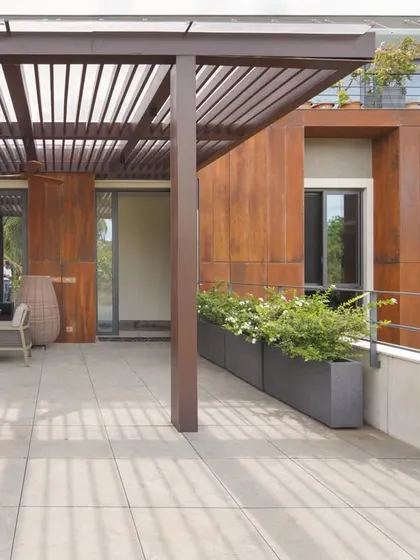 The architecture is organized across multiple levels, allowing the built form to be appreciated from different vantage points. This view shows the connection between two separate outdoor decks.