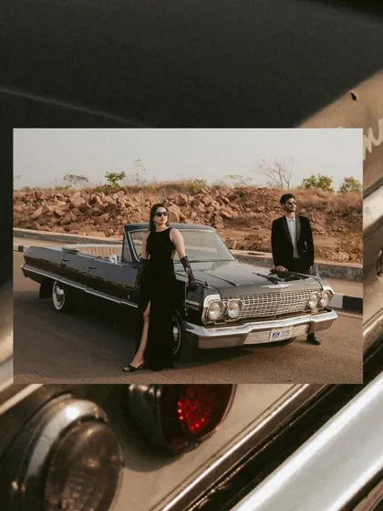 An artistic, layered composition that frames the couple and their vintage car within details of the vehicle itself. This creative approach adds a unique, editorial quality to their Goa pre-wedding album.