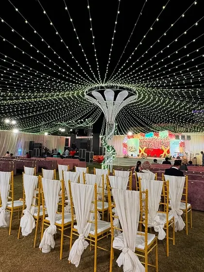 Lighting can completely transform a space. For this outdoor event, I created a stunning canopy of fairy lights radiating from a central structure, making the entire lawn feel like it's under a sky full of stars.