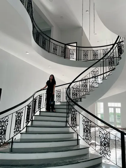 The centerpiece of this Lonavala site is the magnificent curved staircase with custom wrought iron railings. It is a testament to my belief that architectural elements should be both functional and sculptural, adding a sense of drama and movement to the home.