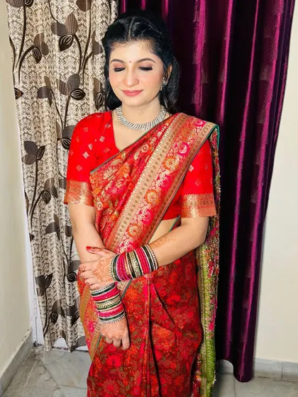 A full view of the Roka bride's look. The red saree and simple jewelry are paired with my signature natural makeup.
