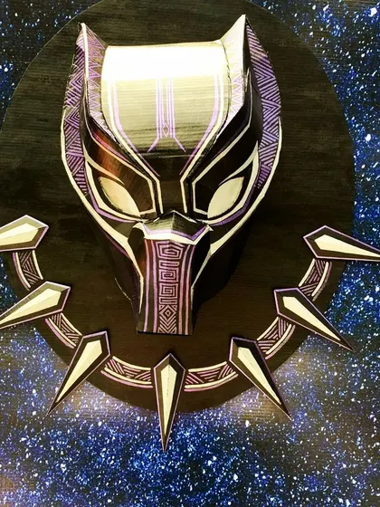 This Black Panther mask installation shows how I use layered cardboard to create depth and intricate detail. Placed against a starry background, it becomes more than just decor; it's a piece of art that sets a powerful, heroic tone for the event.