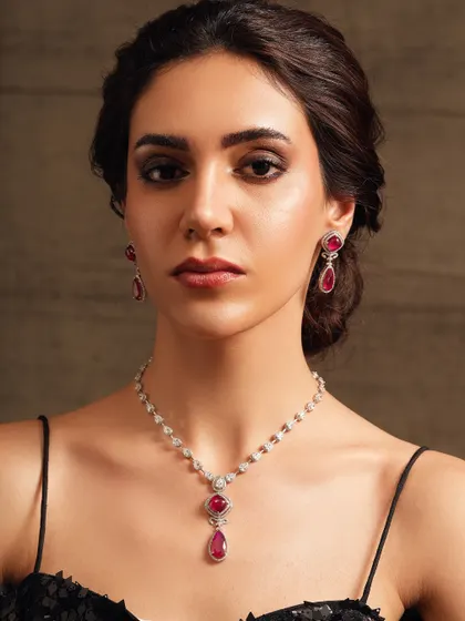 A delicate diamond and ruby pendant necklace, offering a touch of color and sophistication.