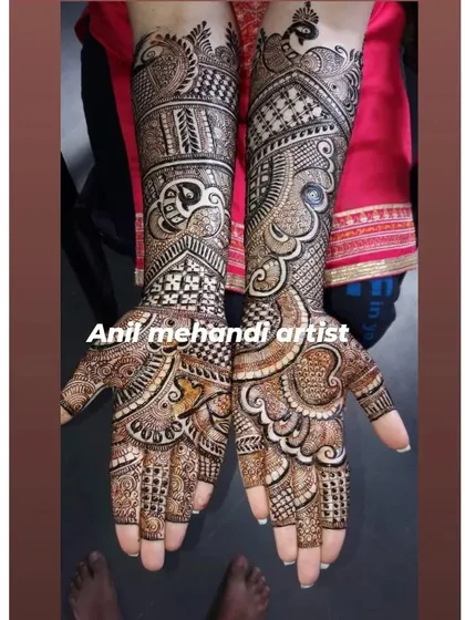 This design features large, swirling paisley and peacock motifs, creating a very dynamic and flowing pattern across the hands and arms.