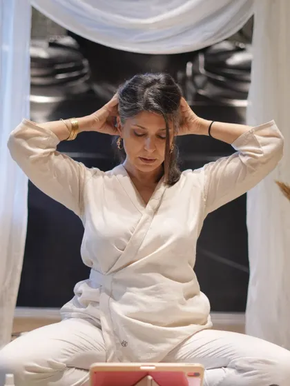 Demonstrating a self-massage technique for the head and neck to release tension. These small, mindful practices are key to managing stress and promoting mental clarity during our sessions.