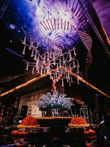 A view of the lobby decor, featuring a stunning floral installation under a dramatic, modern chandelier. This shows how I transform even transitional spaces into works of art.