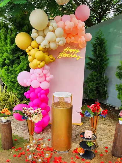 A colorful balloon arrangement in a garden setting, perfect for a bright and cheerful birthday photo spot.