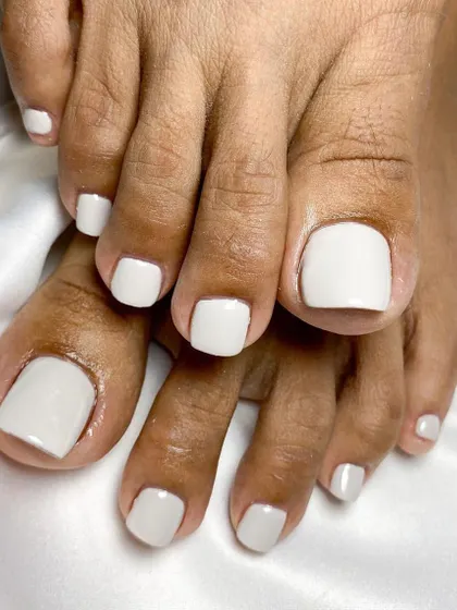 Flawless from head to toe. We used extensions to create these perfectly shaped, uniform toenails, finished with a clean and classic white polish.