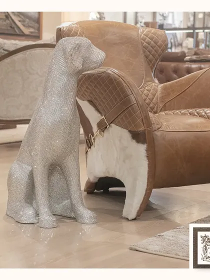 This large, silver-toned dog sculpture, covered in shimmering crystals, is a true statement piece. It adds a luxurious and artistic touch to any room, perfect for a modern or eclectic interior.