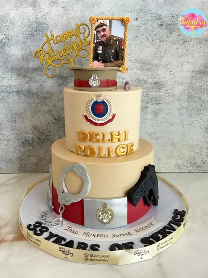 A heartfelt tribute for a retiring police officer, celebrating 33 years of service. I designed this cake with the Delhi Police logo, handcuffs, and a portrait to honor his career.