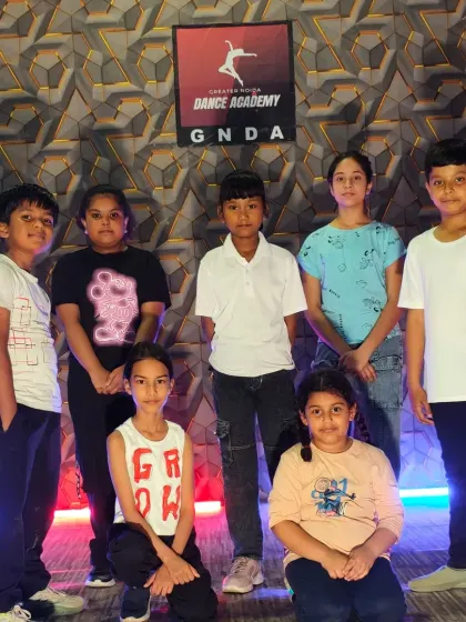 Posing in front of the GNDA logo, our students are the heart of our academy.