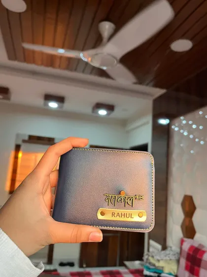 Another angle of the custom blue wallet, showing how the metallic nameplate and charm catch the light. These wallets are designed to be both stylish and durable.