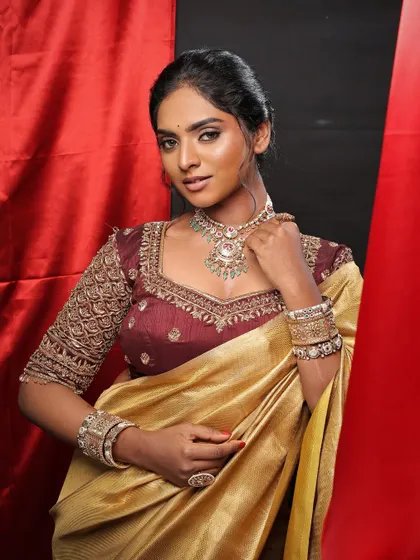 A confident and poised portrait. The makeup is perfectly balanced, with a focus on healthy, glowing skin and softly defined eyes.