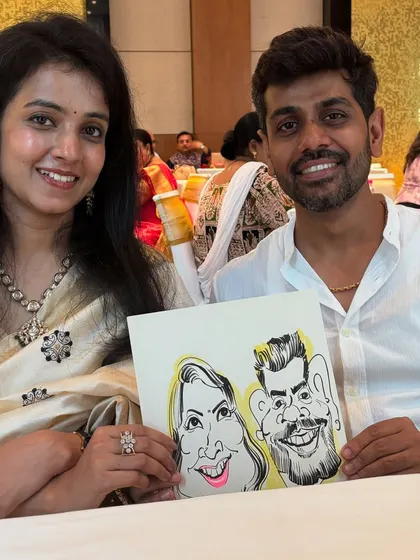 A lovely couple with their caricature, a sweet memento from a social gathering.