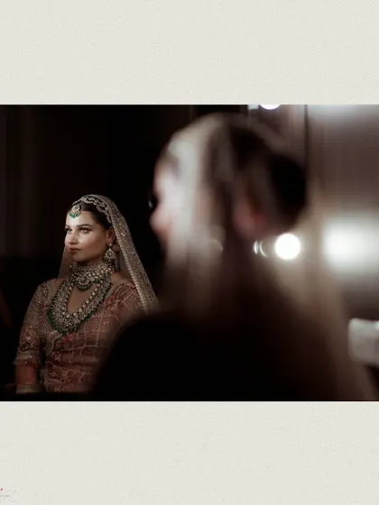 A creative shot of the bride's reflection as she gets her makeup done.