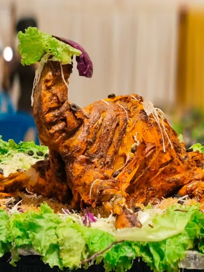 A true showstopper for any main table. This is my whole roasted chicken, marinated in special spices and cooked to perfection, ready to be the centerpiece of your wedding or party feast.