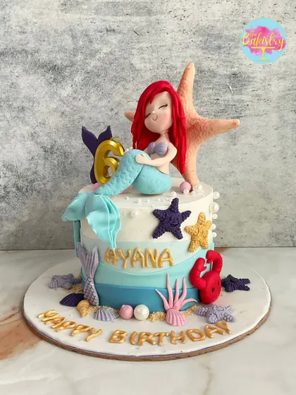 Another enchanting mermaid cake, this one for Ayana's 6th birthday, with a handcrafted Ariel relaxing by a starfish.