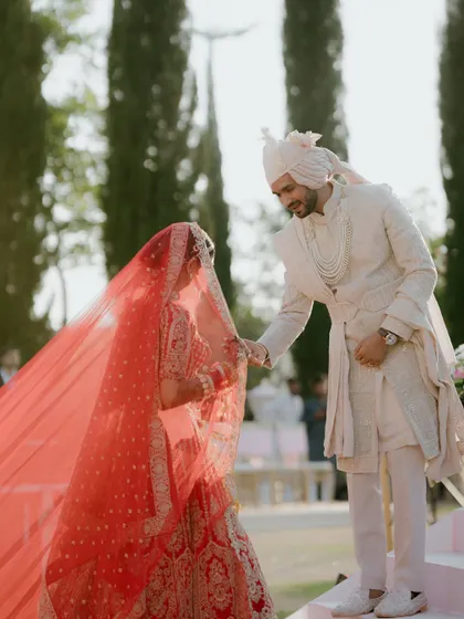 The groom lifts the bride's veil, a tender and timeless moment before they officially become husband and wife. I ensure the photographers are positioned to capture these subtle, emotional interactions.