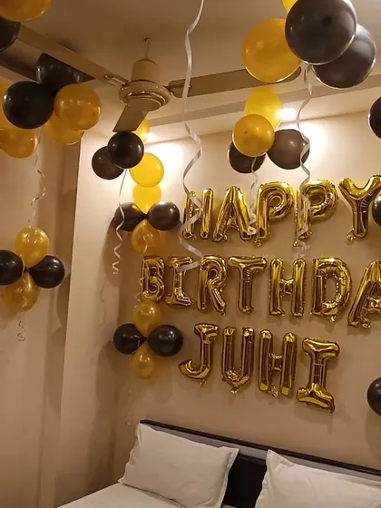 A full view of the black and gold bedroom decoration for Juhi's birthday. It's a simple, classic, and elegant way to surprise someone.