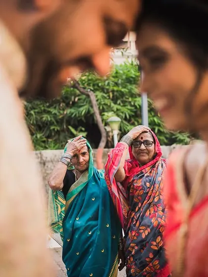 A beautiful moment of tradition during Rinkle and Mayur's engagement, with family blessings framing the couple. We capture the cultural context that makes your story unique.