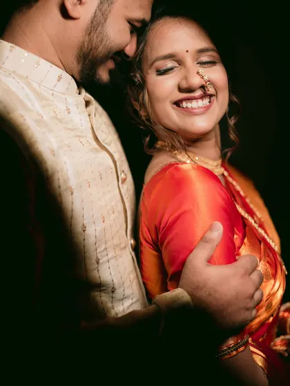 A close-up, intimate portrait of a Maharashtrian couple, filled with genuine laughter and joy.