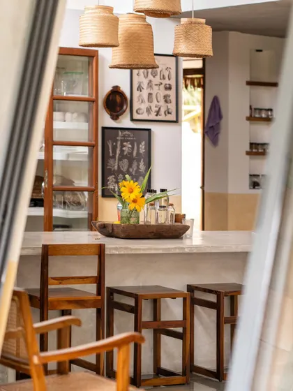 A glimpse into the kitchen, where pantry shutters upcycled from an old shop and a counter made with cement and oyster shells showcase my resourceful approach. The design makes the kitchen a fluid, functional, and beautiful workspace.