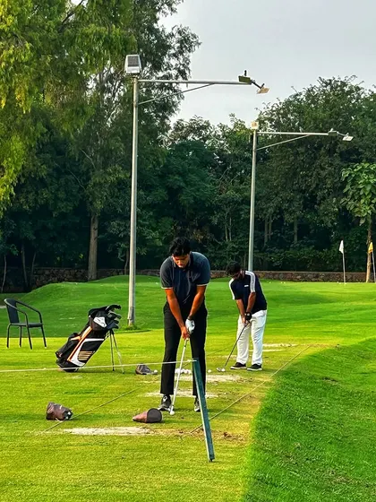 Two golfers work on their game side-by-side. Whether you come for a lesson or just to practice, our coaches are always around to offer a helpful tip.