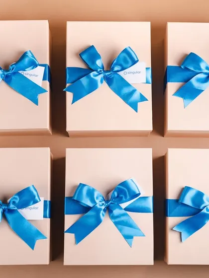 A top-down view of the Singular welcome boxes, each tied with a perfect bright blue bow. Consistency in presentation is key for bulk corporate orders.