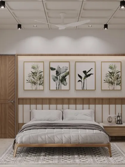 A calm and balanced bedroom featuring a paneled headboard and a series of botanical art prints. The design uses a neutral palette with wood tones to create a soothing and grounded atmosphere.