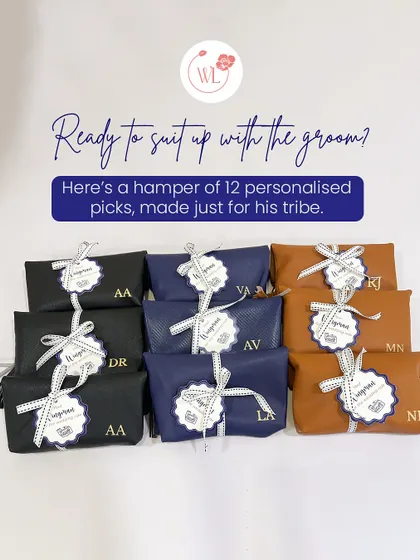 Ready to suit up with the groom? This hamper includes 12 personalized picks for his tribe, including these stylish custom-initialed pouches in black, navy, and tan leather.