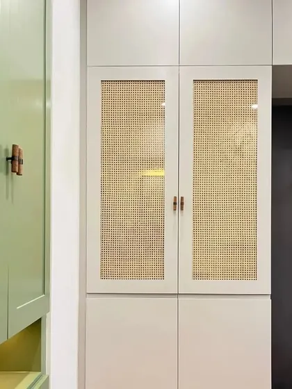 I love weaving sustainable materials into my designs. This modern wardrobe combines sage green and beige tones with natural wicker door panels for a fresh, eco-friendly look.