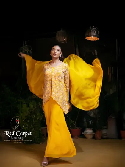 A powerful stance in a stunning yellow ensemble. The fully embroidered jacket and flowing palazzo pants make a bold and confident statement.