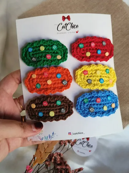 Holding up a full card of our Girly Gems clips, a fun and trendy accessory for parties.