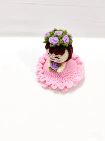 A top-down view showing the doll's intricate flower crown.