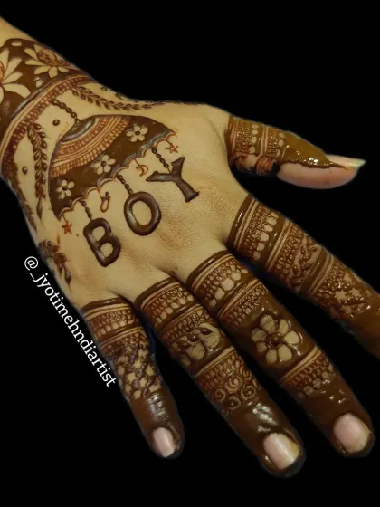 The same "BOY" gender reveal design, shown with the fresh henna paste. The lines are sharp and bold, ensuring a clear and beautiful final stain.