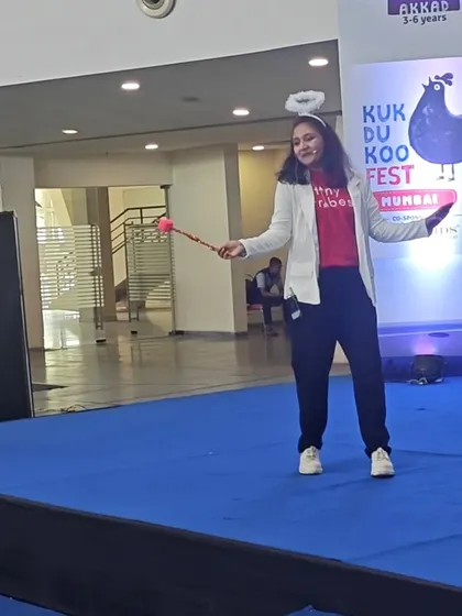 One of our teachers dressed as an angel with a magic wand, bringing a story to life on stage. Our performances are not about perfect costumes, but about using simple items to create a world of imagination.