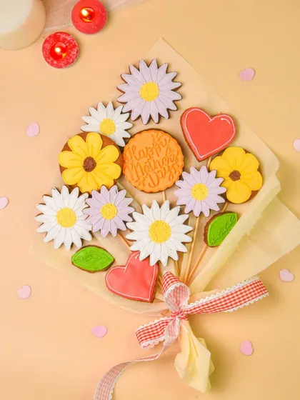 A creative and beautiful cookie bouquet with flower and heart-shaped decorated cookies, perfect for a bakery's special occasion offerings.