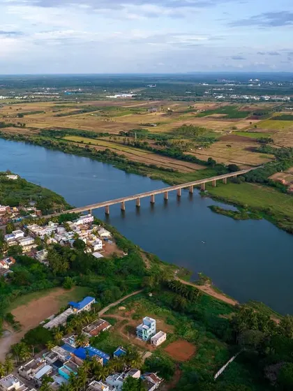 A bridge connects two banks of a river in rural Karnataka. A simple, beautiful scene of life in the countryside.