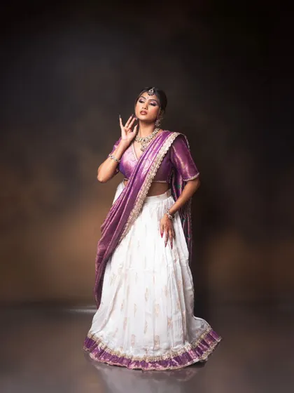A graceful and modern ethnic look. I created a dramatic purple winged eyeshadow to match the saree, paired with a sophisticated updo and oxidized jewelry for a contemporary reception look.