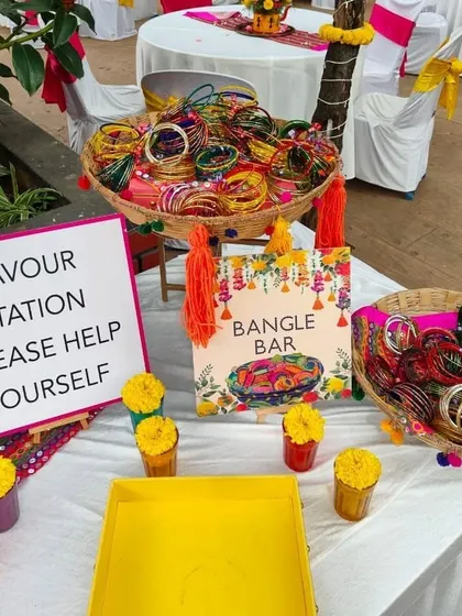 A vibrant "Bangle Bar" favor station, where guests can help themselves to colorful bangles as a keepsake from the celebration.