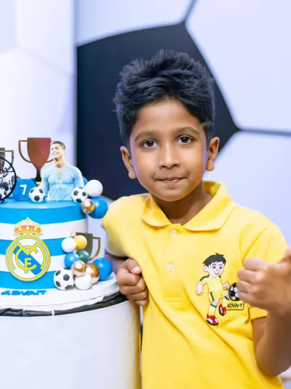 The happy birthday boy with his Ronaldo-themed cake. A thumbs-up for a winning celebration!