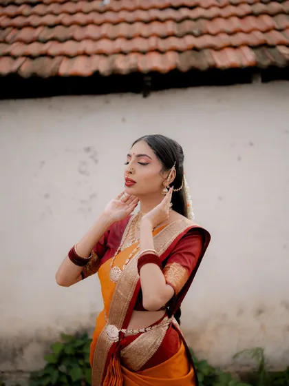 A serene moment with eyes closed. This pose conveys a sense of peace and inner joy, highlighting the bride's beautiful makeup and jewelry.