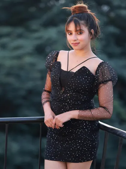 A three-quarter shot from the terrace railing, showcasing the puffy sleeves of the dress.