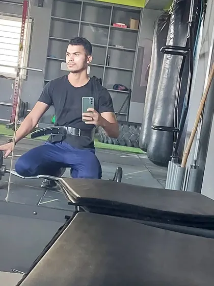 Taking a moment after a solid back and biceps workout. A weight belt provides extra support for heavy lifts, which is something we can incorporate as you progress.