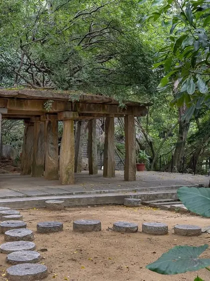 The ancient Stone Mantapa, nestled in a quieter part of the garden, feels like a discovery. Its weathered stone pillars tell a story of centuries past.