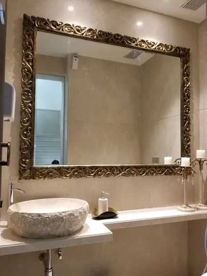 Oversized mirrors can completely transform a space. In this lobby bathroom at our Bellevue project, we used a large, ornate mirror to create a sense of opulence and grandeur.